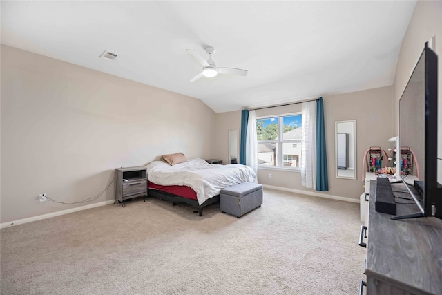 carpeted bedroom with vaulted ceiling and ceiling fan