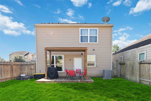 back of house featuring a lawn, central AC, and a deck