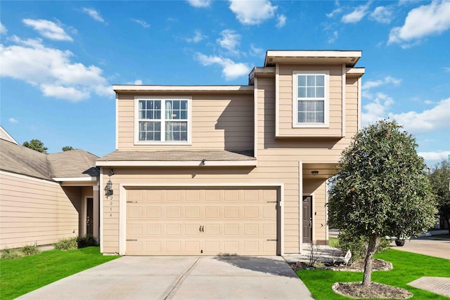 view of front property featuring a garage and a front lawn