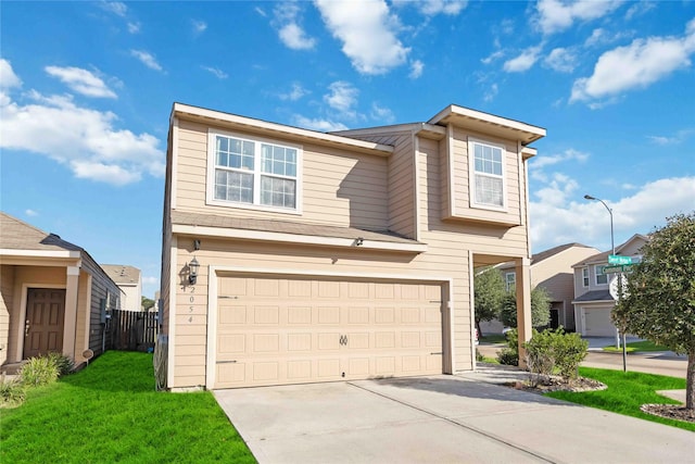 view of front of home featuring a front yard and a garage