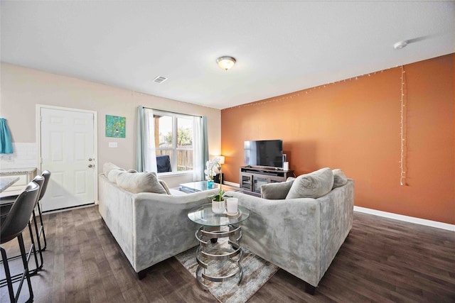 living room featuring dark wood-type flooring