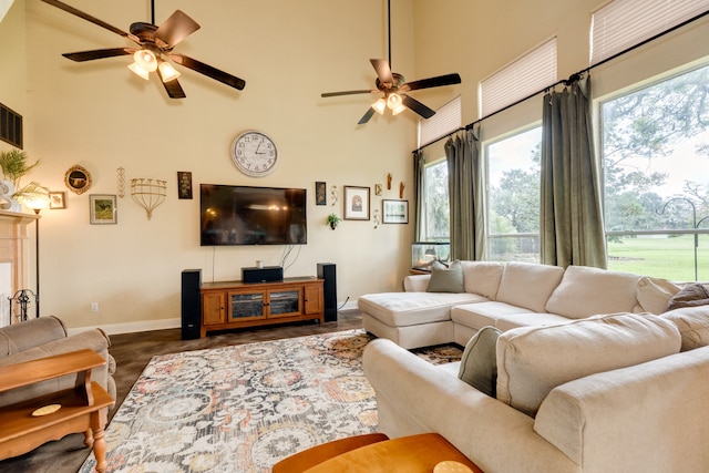 living room featuring a high ceiling and ceiling fan