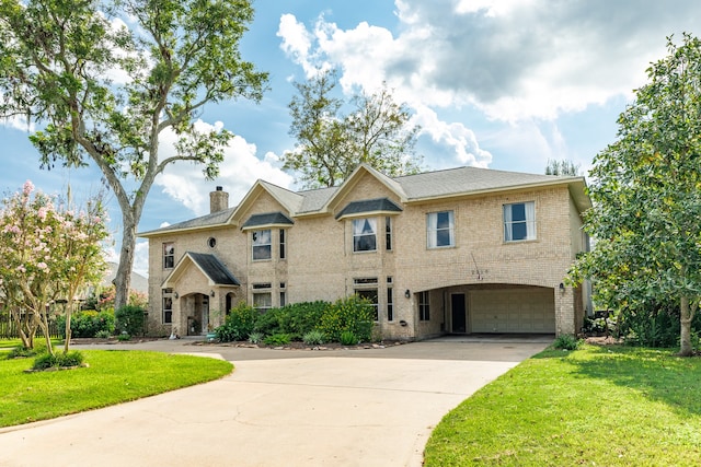 view of front of property with a garage and a front lawn