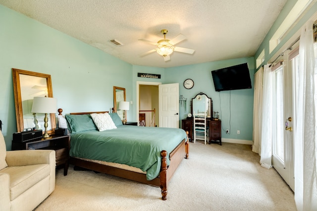 carpeted bedroom with a textured ceiling and ceiling fan