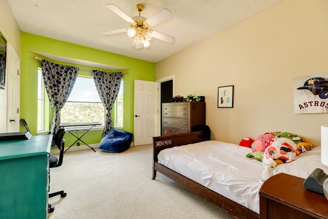 carpeted bedroom featuring a textured ceiling and ceiling fan