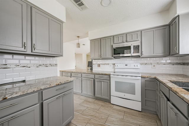 kitchen featuring gray cabinets, a textured ceiling, white electric stove, and hanging light fixtures