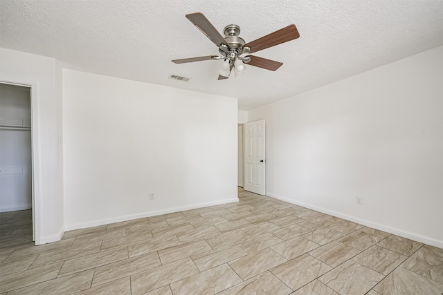 interior space with ceiling fan and a textured ceiling