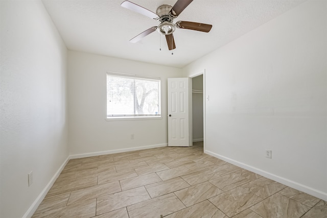 spare room with ceiling fan and a textured ceiling