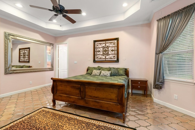 bedroom with a tray ceiling, ceiling fan, and crown molding