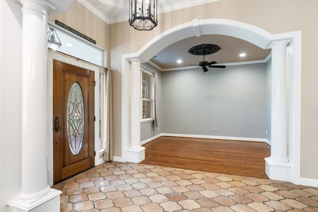 entryway featuring crown molding, ceiling fan with notable chandelier, and light wood-type flooring