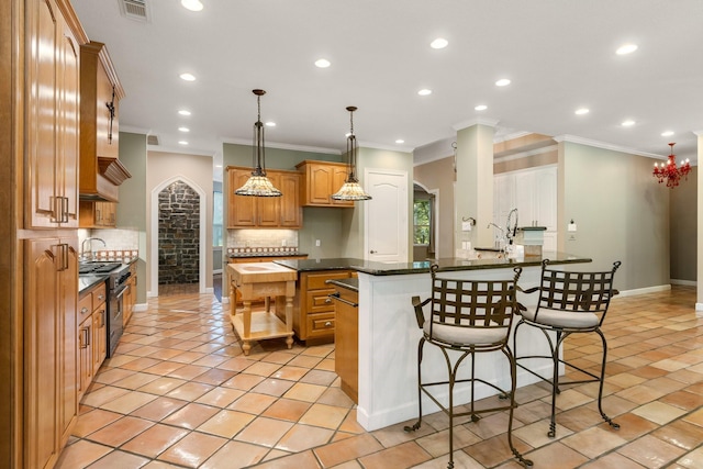 kitchen with decorative backsplash, crown molding, dark stone counters, and sink