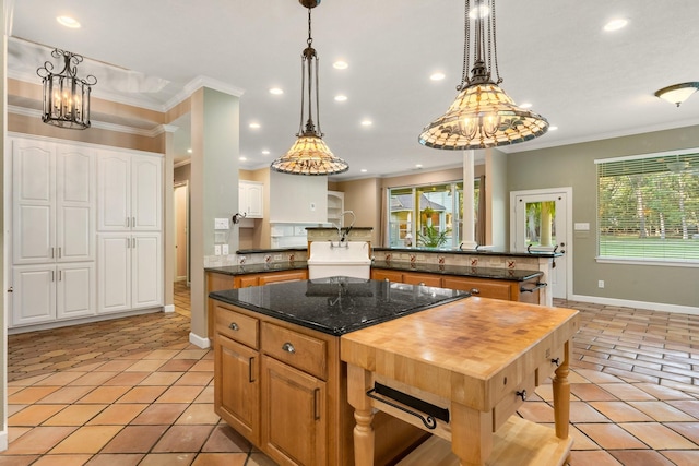 kitchen featuring white cabinets, a center island, and light tile patterned floors