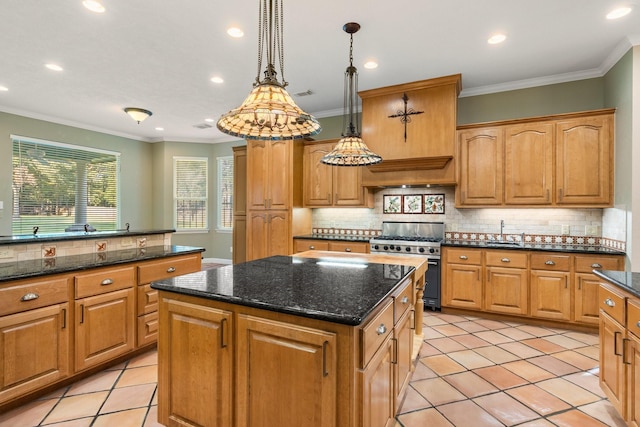 kitchen with backsplash, stainless steel range, crown molding, pendant lighting, and a kitchen island