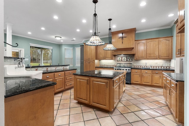 kitchen featuring high end stove, decorative light fixtures, a kitchen island, and crown molding