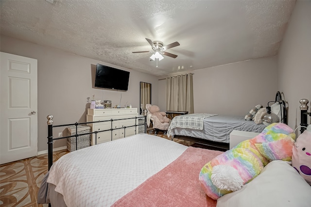 bedroom with a textured ceiling and ceiling fan