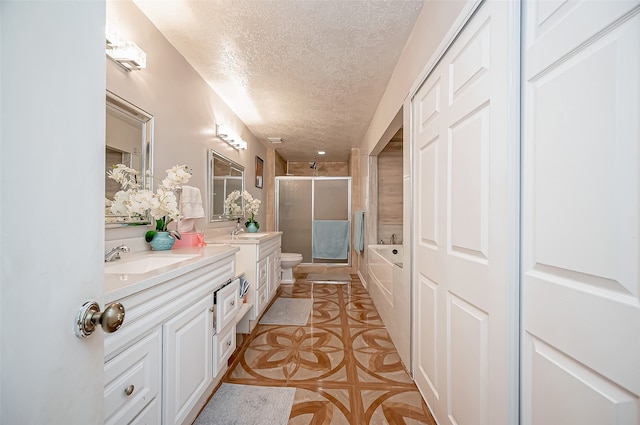 full bathroom featuring a textured ceiling, vanity, separate shower and tub, toilet, and tile patterned floors