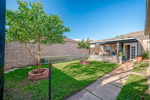 view of yard featuring an outdoor fire pit and a patio