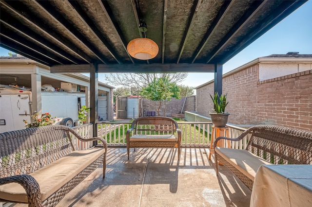 view of patio featuring an outdoor living space and a shed