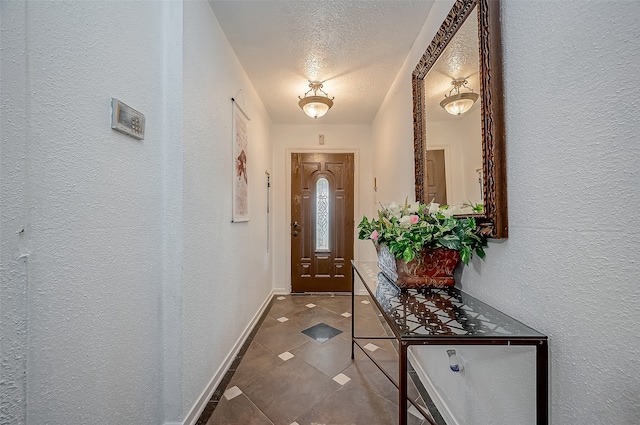 doorway featuring tile patterned flooring and a textured ceiling