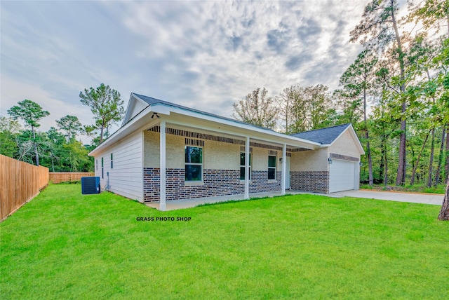 448 Brahman, Onalaska, TX 77360 - view of front of property featuring driveway, a garage, brick siding, and covered porch