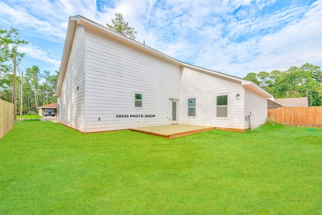 rear view of house featuring a lawn