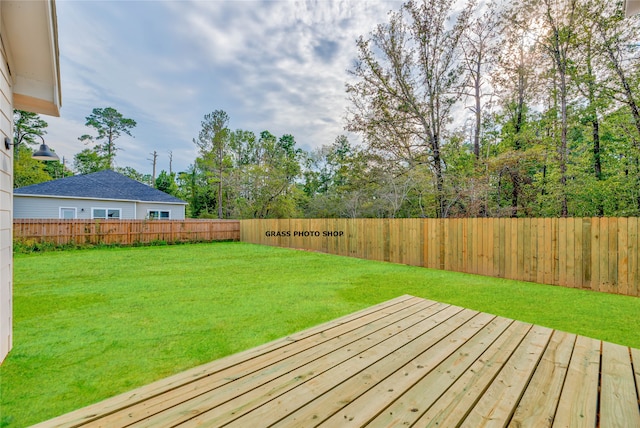 wooden deck with a lawn