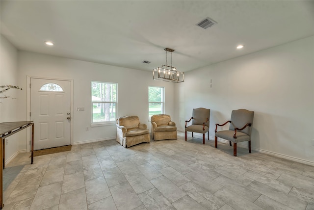 entrance foyer featuring an inviting chandelier