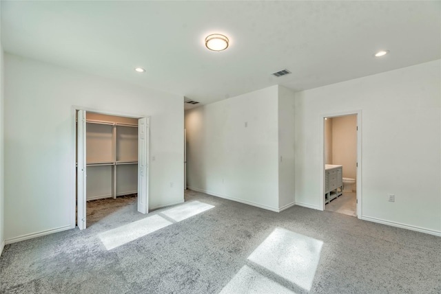 448 Brahman, Onalaska, TX 77360 - unfurnished bedroom featuring recessed lighting, light carpet, a walk in closet, ensuite bath, and a closet