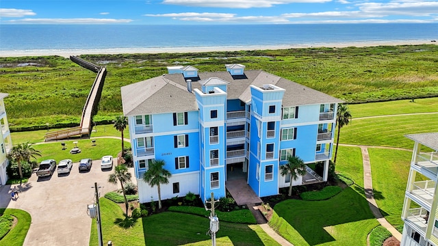 birds eye view of property featuring a beach view and a water view