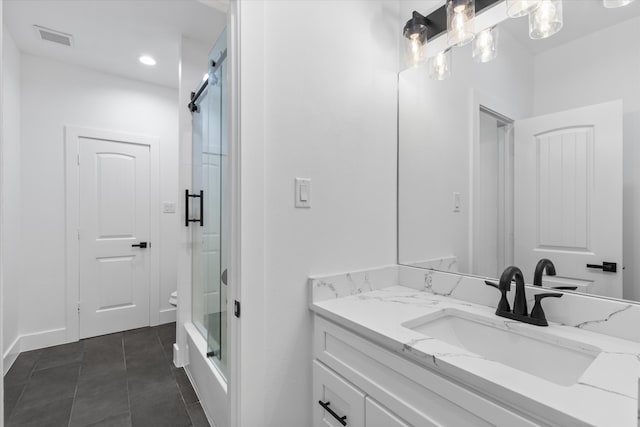 bathroom with tile patterned flooring, vanity, and an enclosed shower