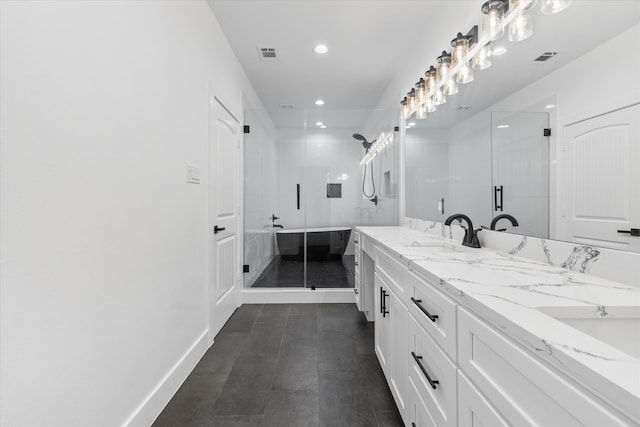 bathroom featuring vanity and a shower with door