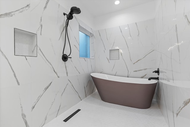 bathroom with tile walls and independent shower and bath