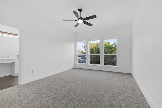 carpeted spare room with ceiling fan