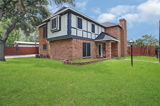 rear view of house featuring a yard