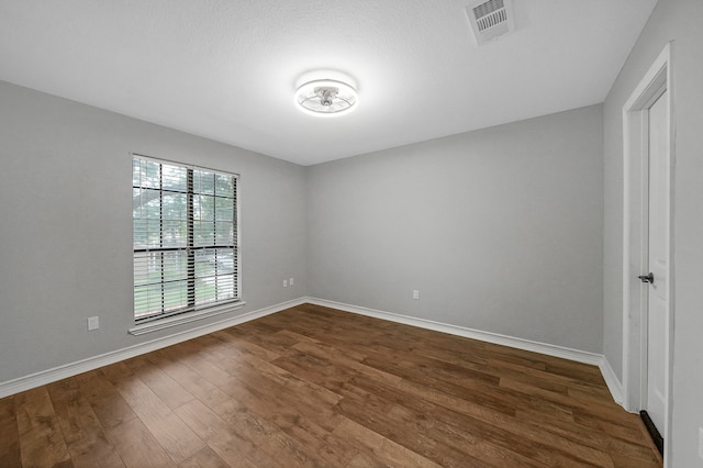 interior space with dark hardwood / wood-style flooring and a textured ceiling