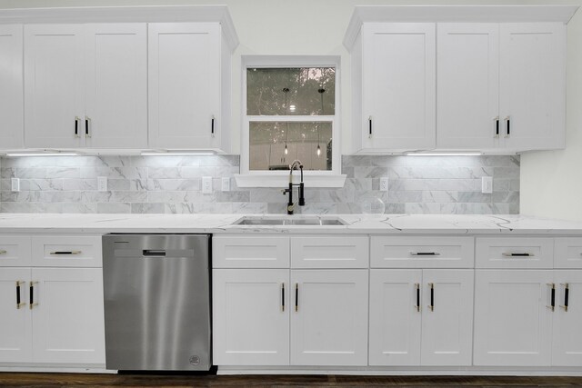 kitchen featuring stainless steel dishwasher, dark wood-type flooring, sink, light stone counters, and white cabinets