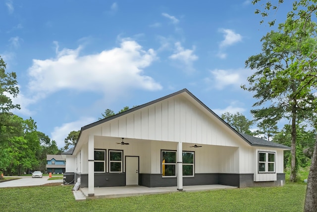 back of property featuring a patio area, a yard, central AC, and ceiling fan