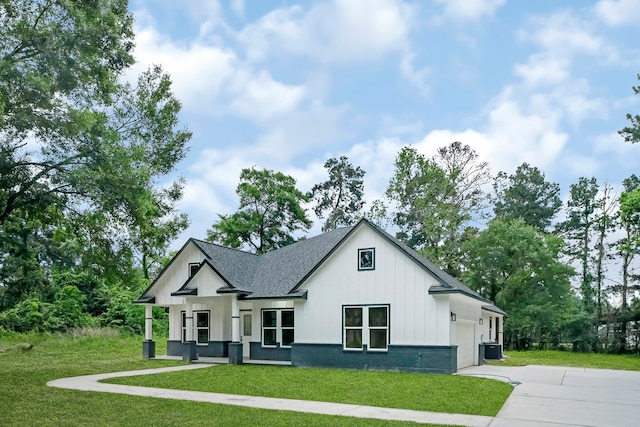 modern farmhouse style home featuring a garage, central AC unit, and a front lawn