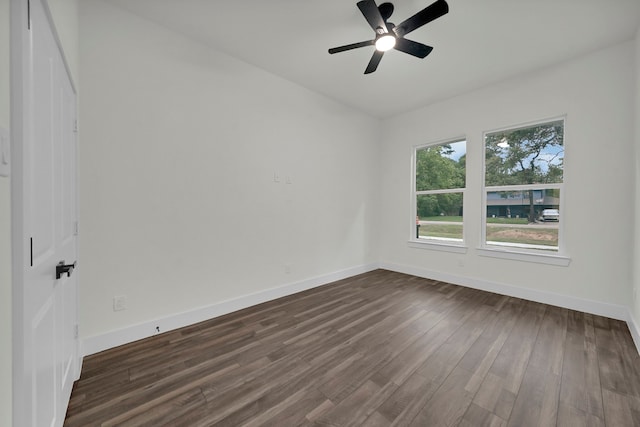 empty room with ceiling fan and dark hardwood / wood-style floors