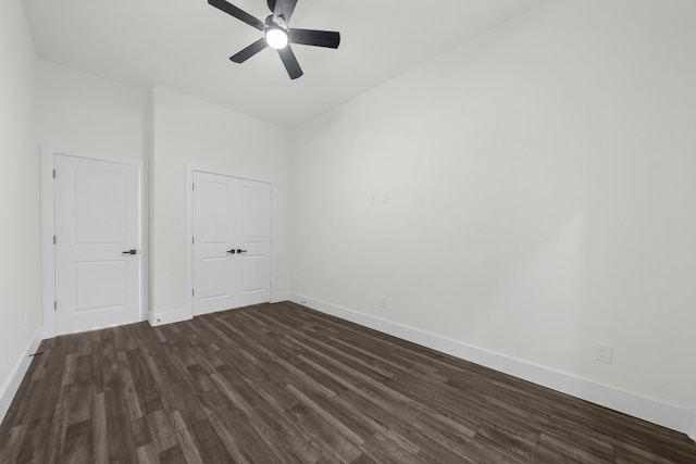 unfurnished room featuring ceiling fan and dark hardwood / wood-style flooring