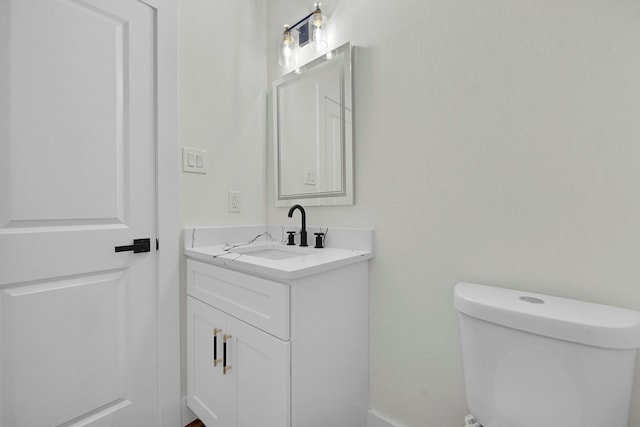 bathroom with toilet and vanity