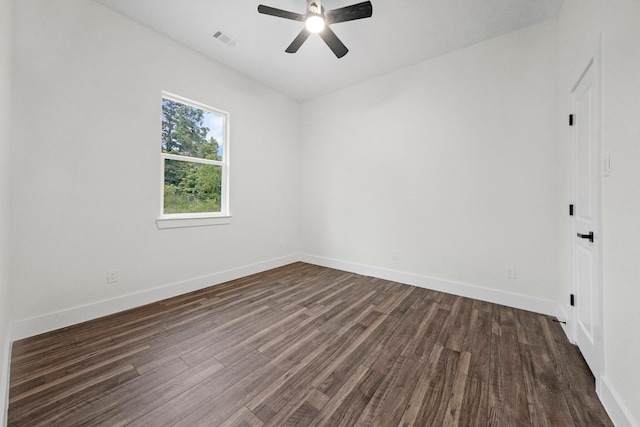 empty room with ceiling fan and dark hardwood / wood-style flooring