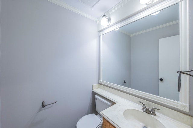 bathroom with vanity, crown molding, and toilet