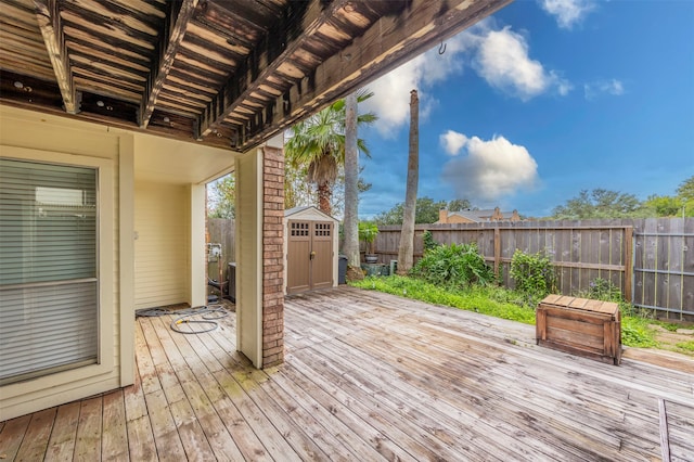 wooden terrace featuring a storage shed