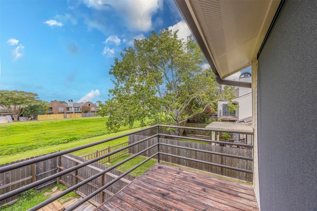 wooden deck featuring a yard