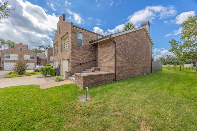 view of home's exterior featuring a garage and a yard