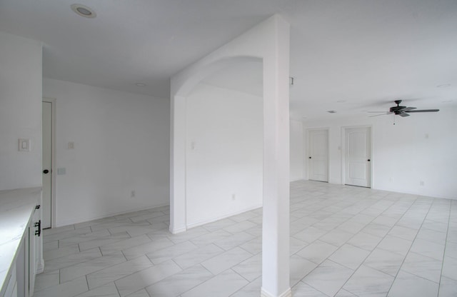 unfurnished room with ceiling fan and light tile patterned floors