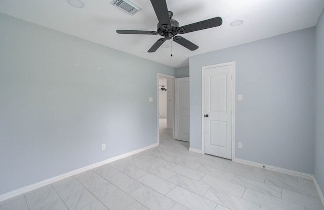 interior space with light tile patterned floors and ceiling fan