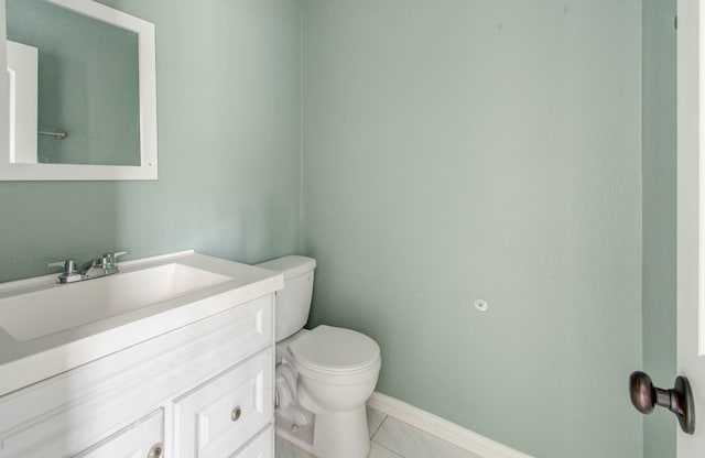 bathroom featuring tile patterned floors, toilet, and vanity