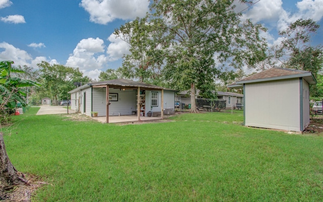 rear view of house featuring a yard and a patio